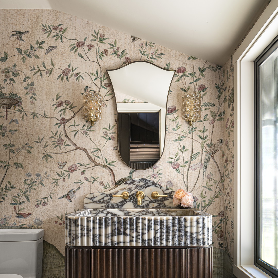 a bathroom with a sink, toilet and mirror