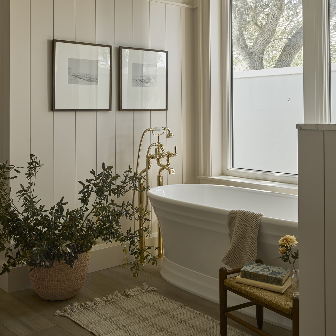 a white bath tub sitting next to a window