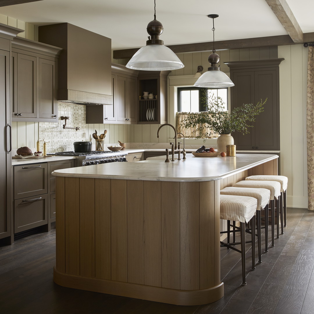 a large kitchen with a center island with stools