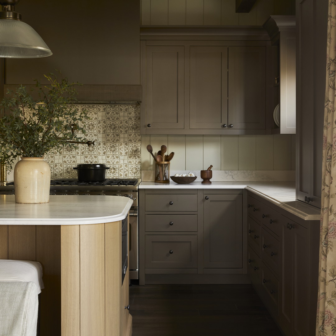 a kitchen with a sink, stove, and cabinets