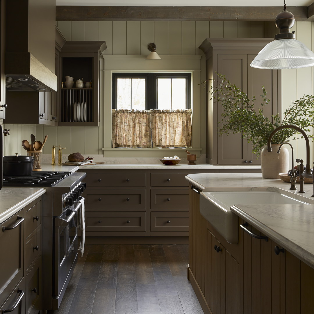 a kitchen with a sink, stove, oven and a window