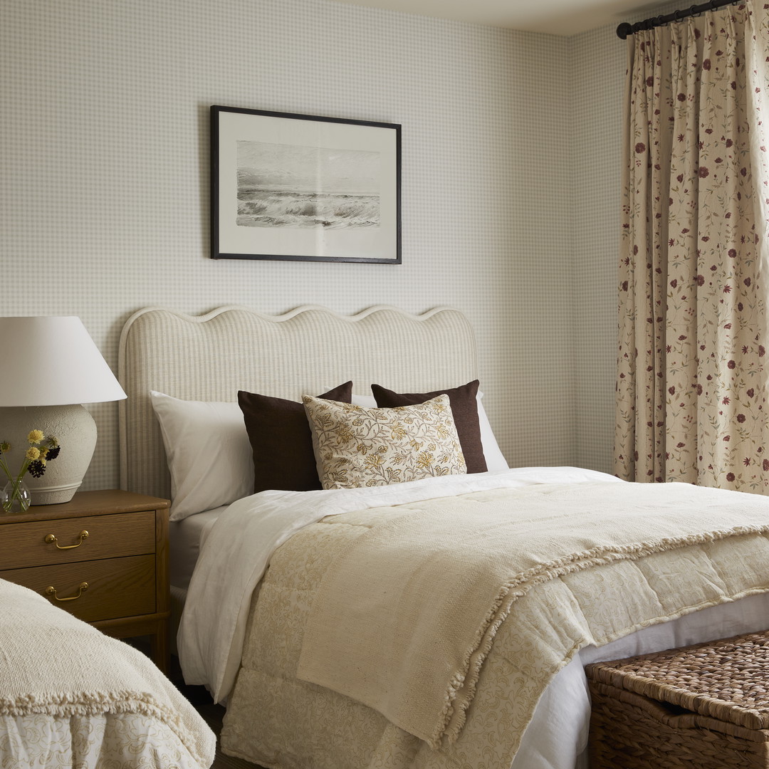 a bedroom with two beds and a basket on the floor