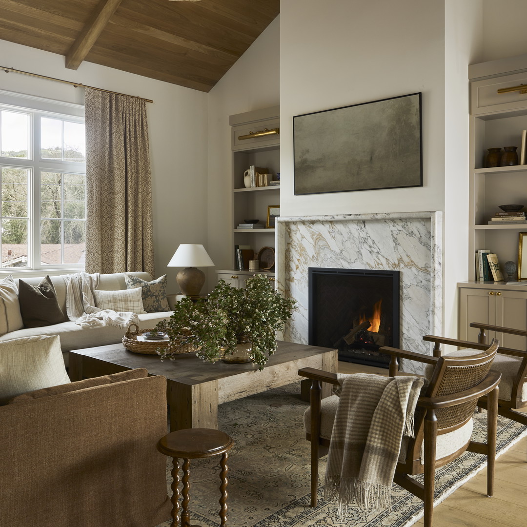 a living room filled with furniture and a fire place