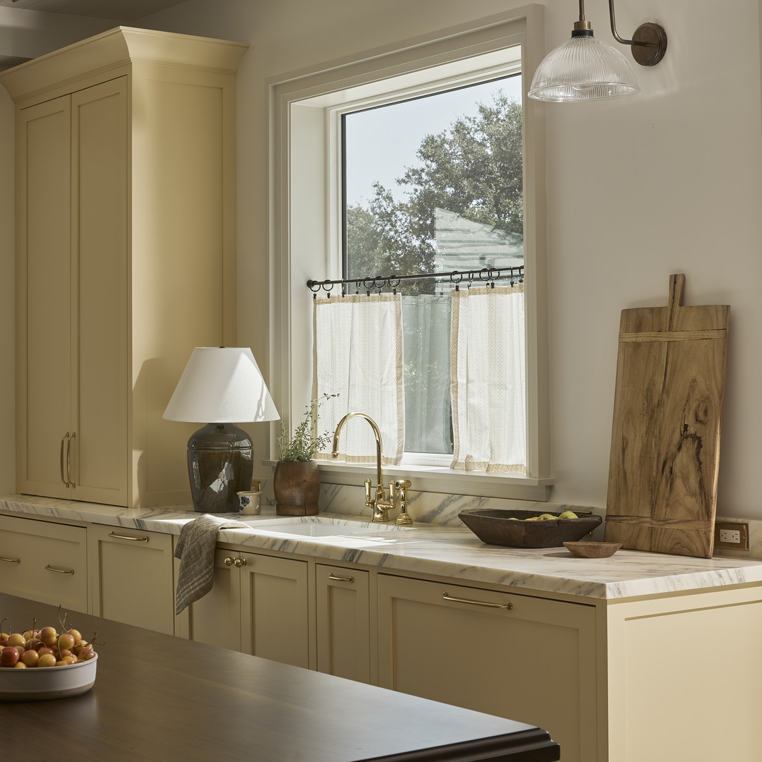 a kitchen with a bowl of fruit on the counter