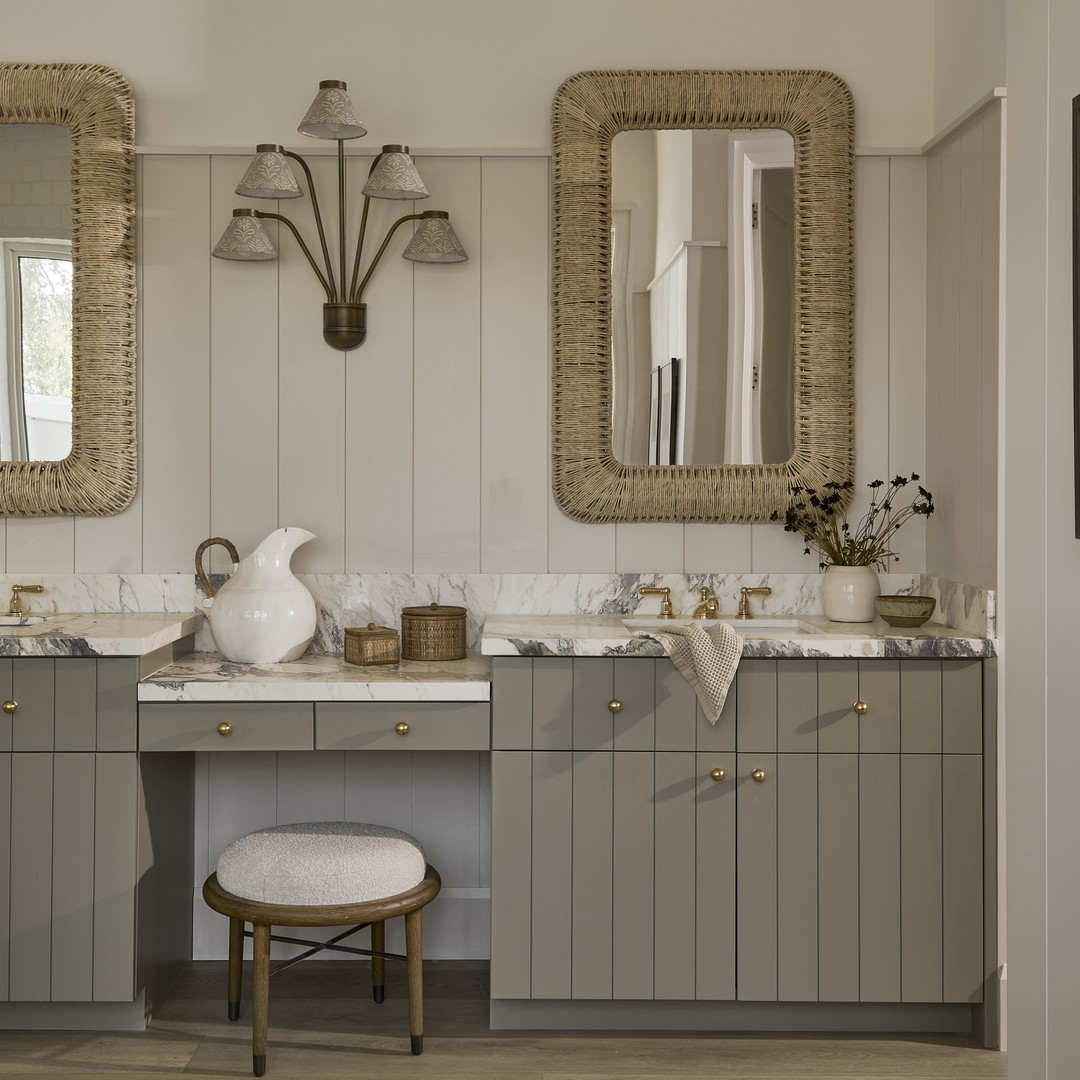 a bathroom with two sinks and a stool