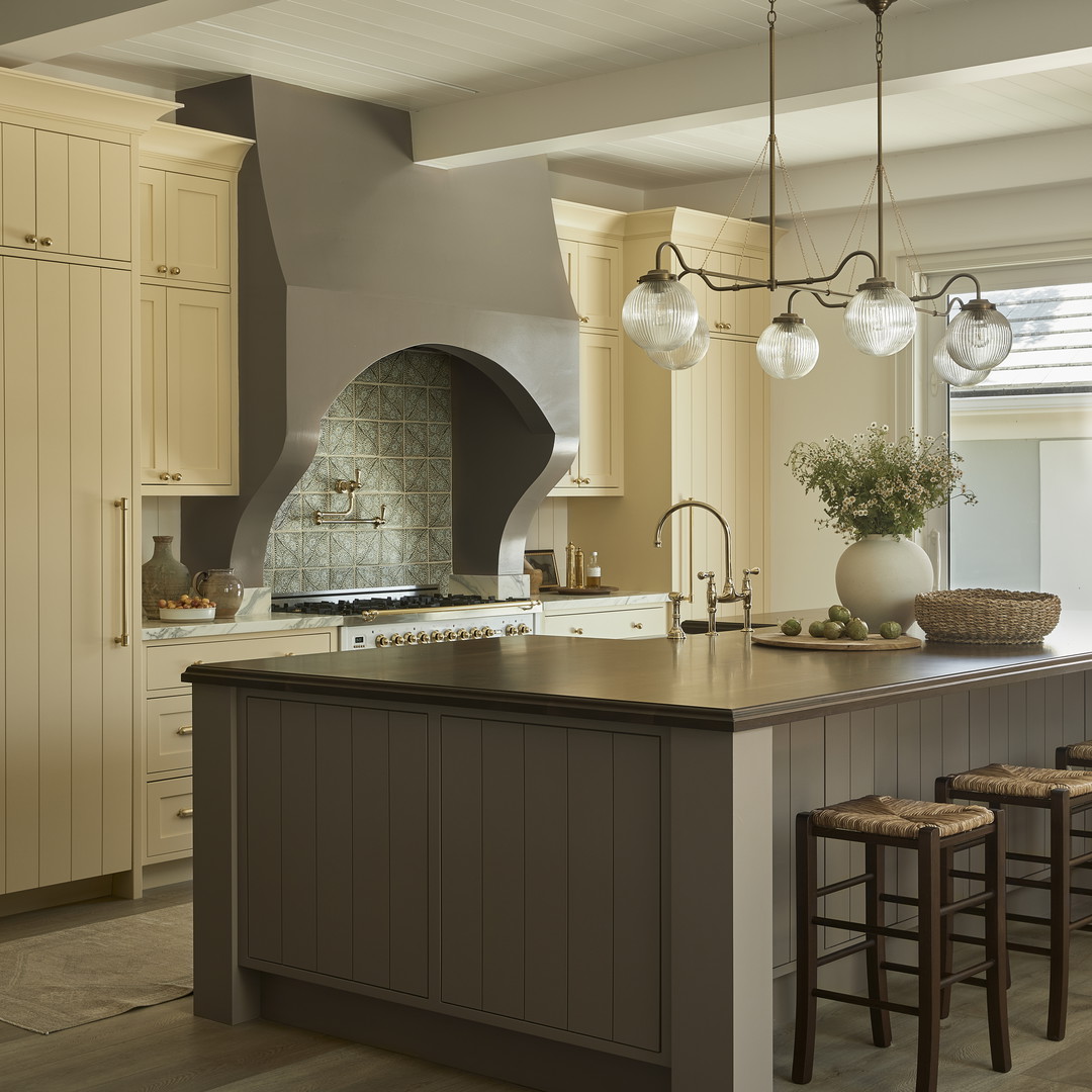 a large kitchen with a center island and two stools