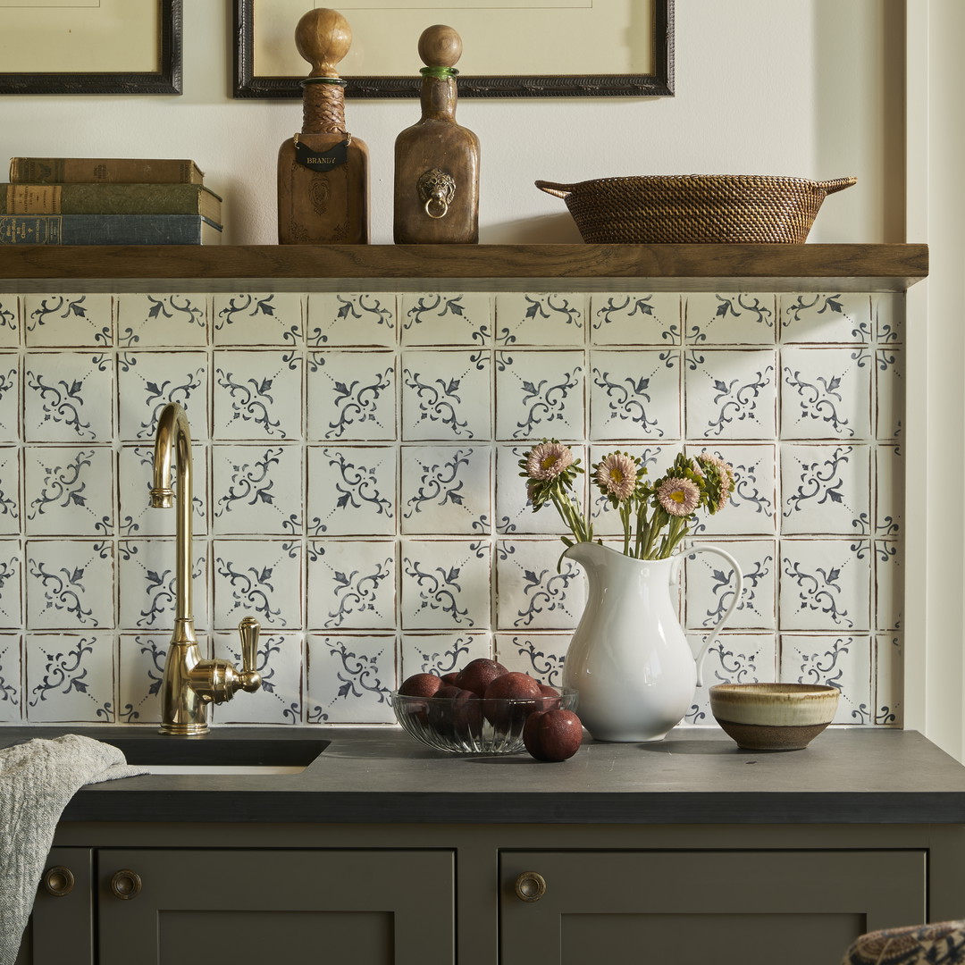 a kitchen counter with a vase of flowers on top of it