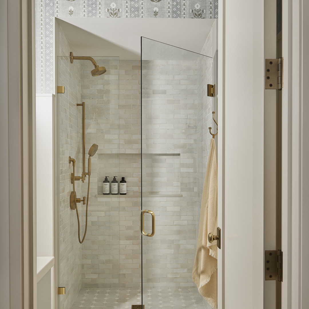 a walk in shower with a glass door