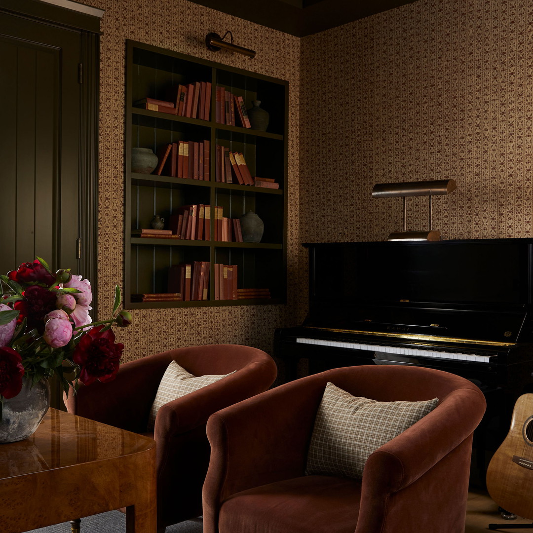 a living room filled with furniture and a piano