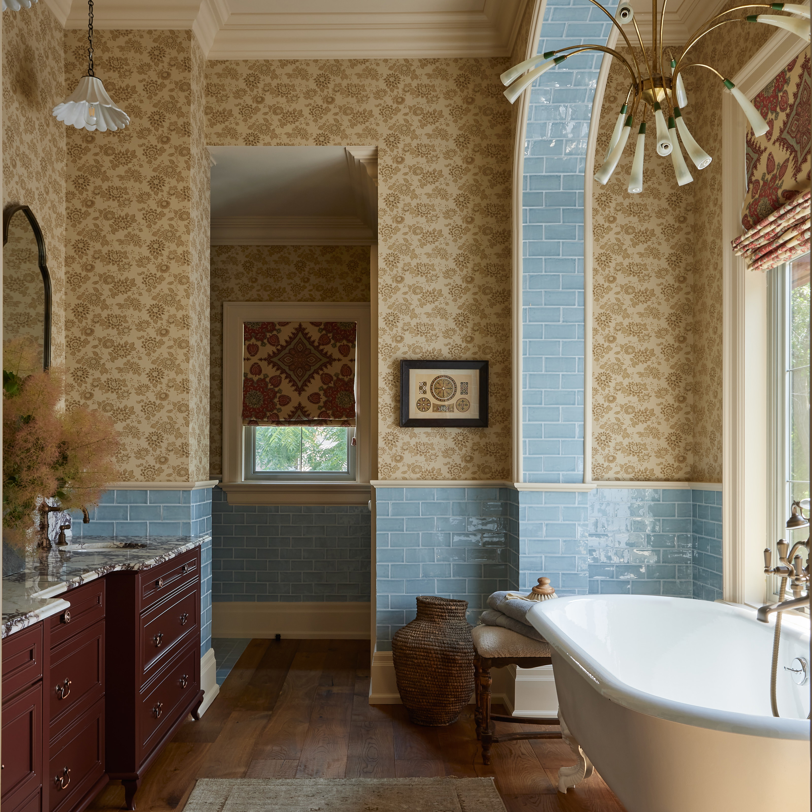 a bath room with a tub a sink and a mirror