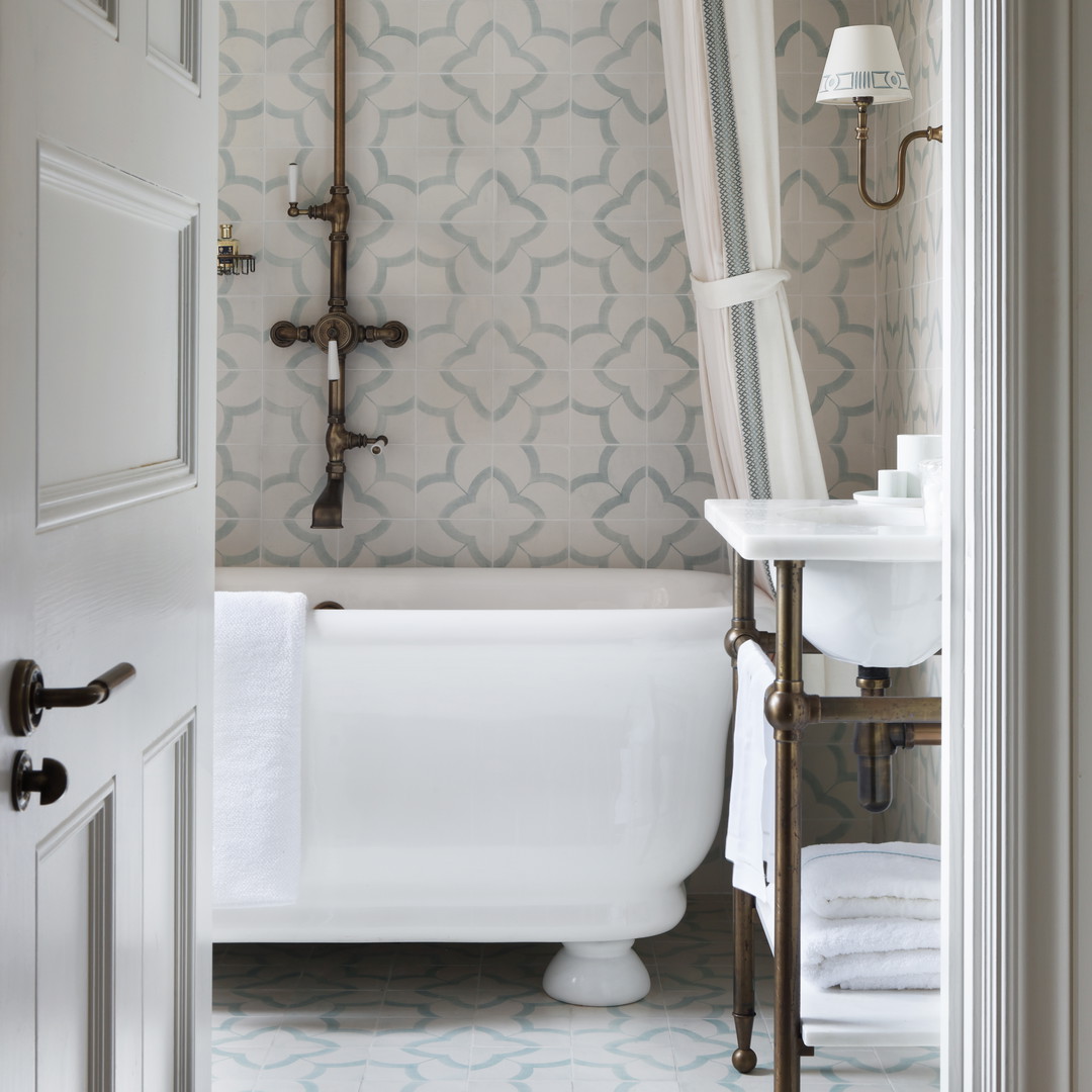 a bathroom with a tub, sink, and shower curtain