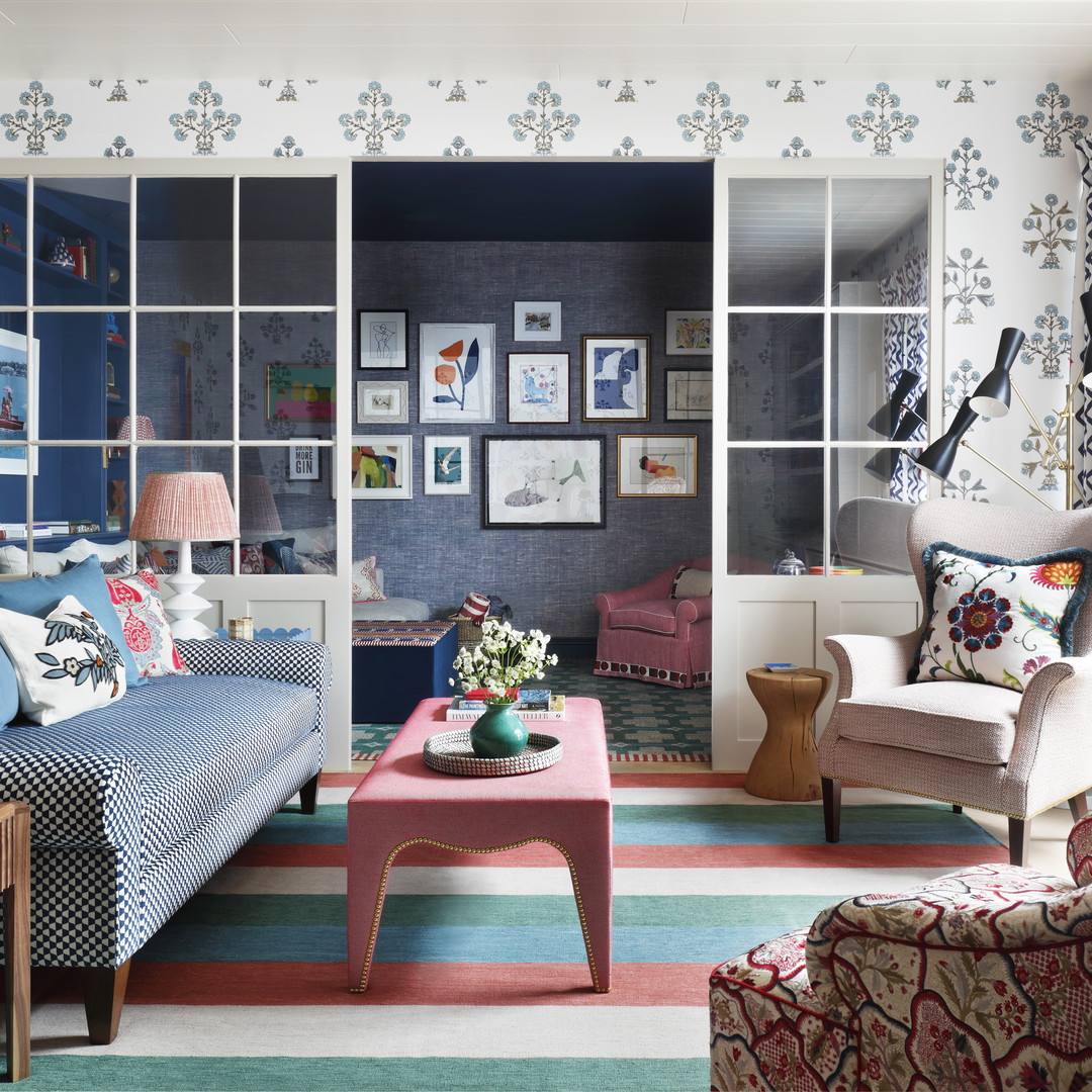 a living room filled with furniture and a colorful rug