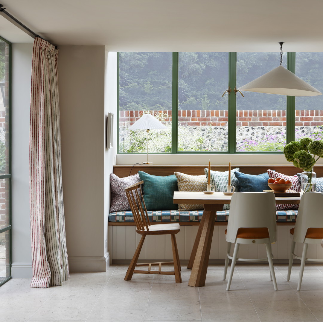 a kitchen with a table, chairs and a bench