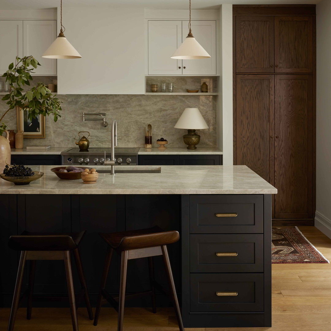 a kitchen with a center island and two stools