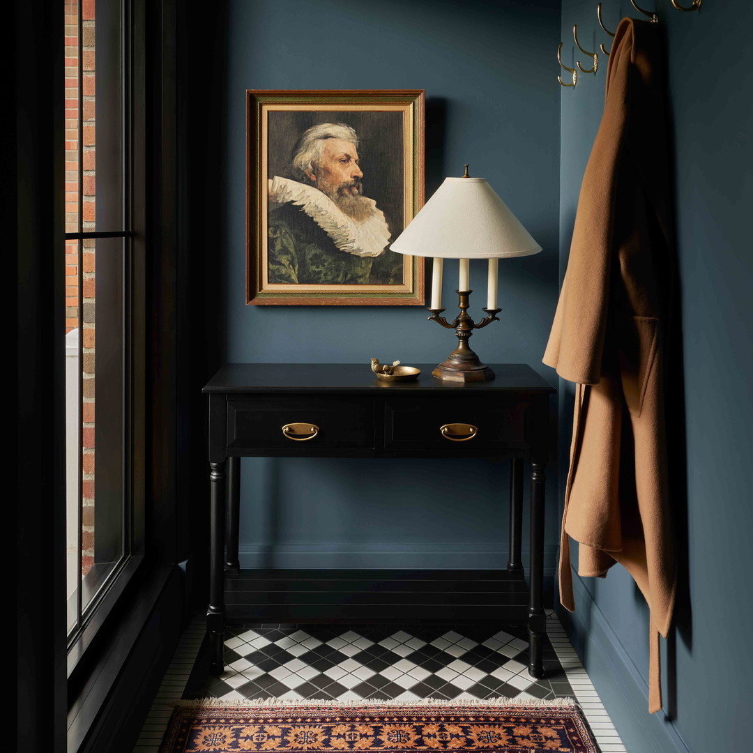 a room with blue walls and a painting on the wall