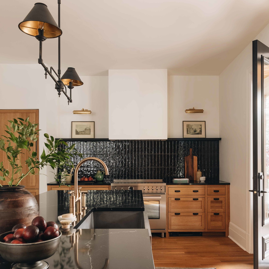 a kitchen with a black counter top and wooden cabinets