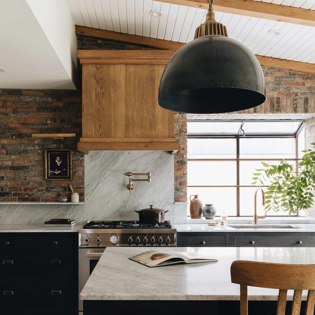 a kitchen with a table, stove, and chairs