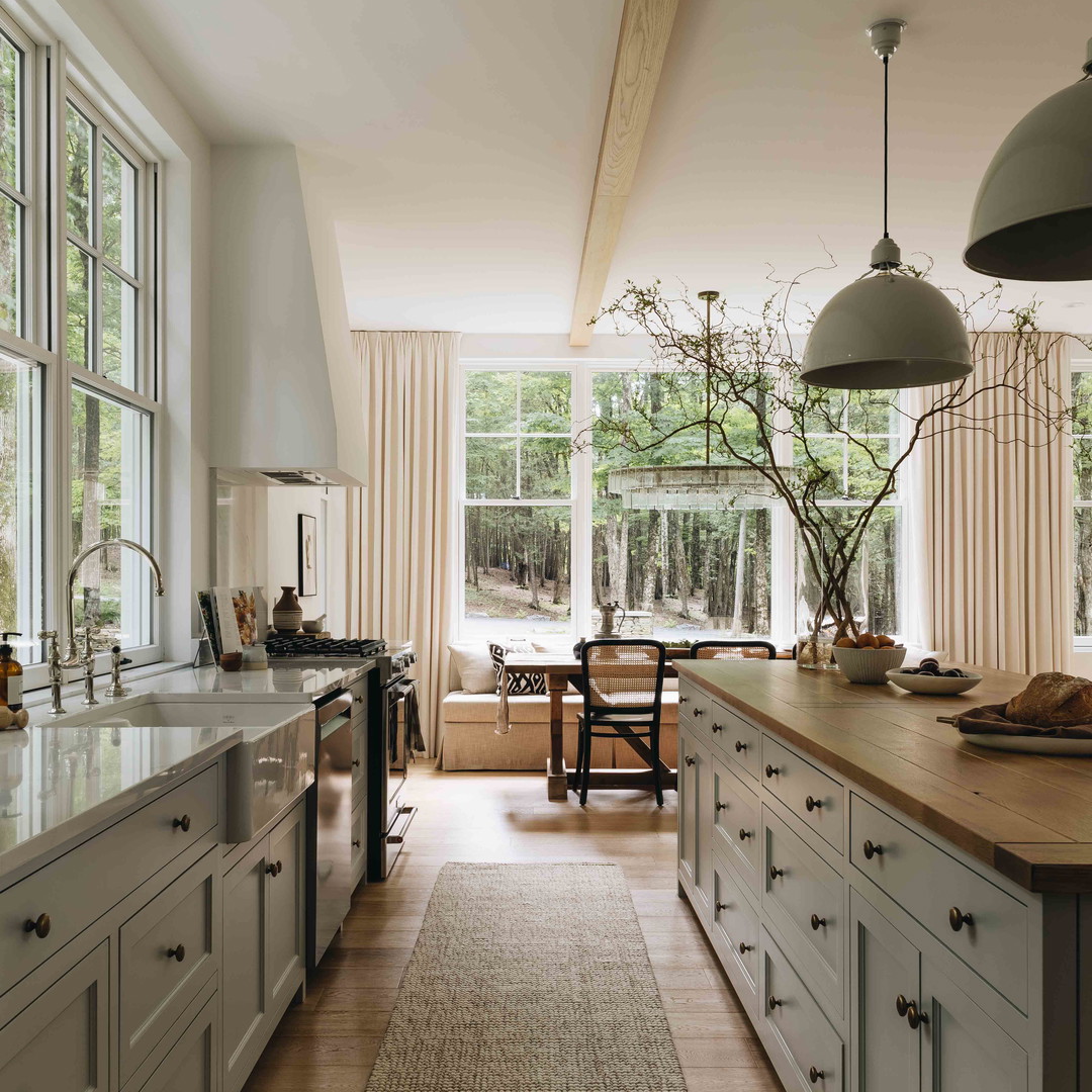 a large kitchen with a wooden floor and white cabinets