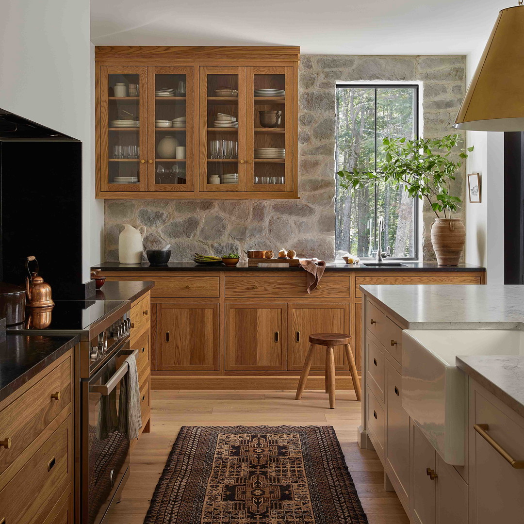 a kitchen with wooden cabinets and a rug on the floor