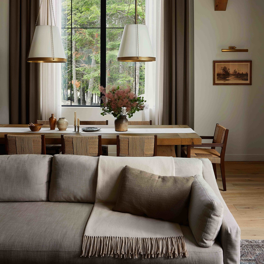 a living room filled with furniture and a large window