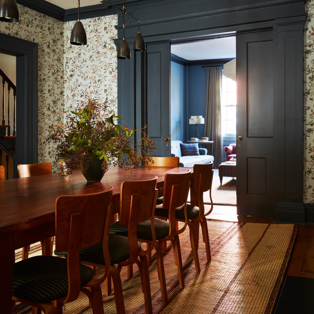 a dining room with a table and chairs