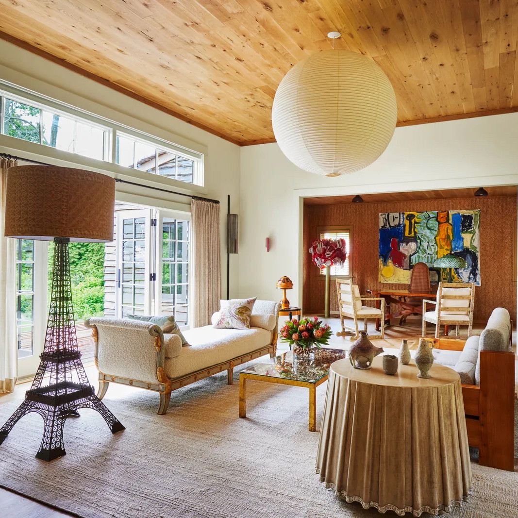 a living room filled with furniture and a large window