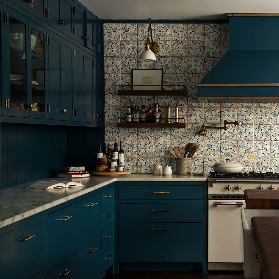 a kitchen with blue cabinets and a wooden counter top