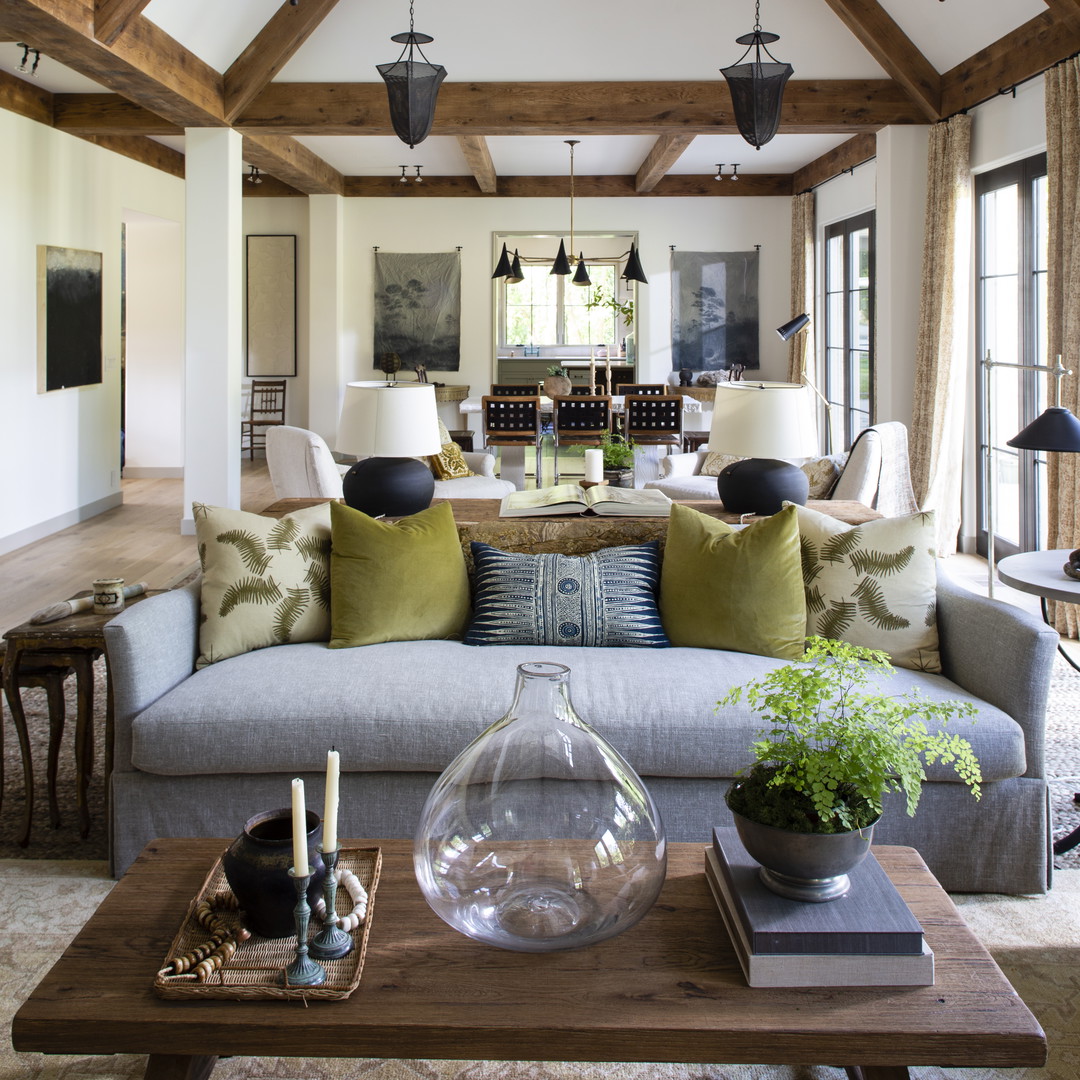 a living room filled with furniture and lots of windows