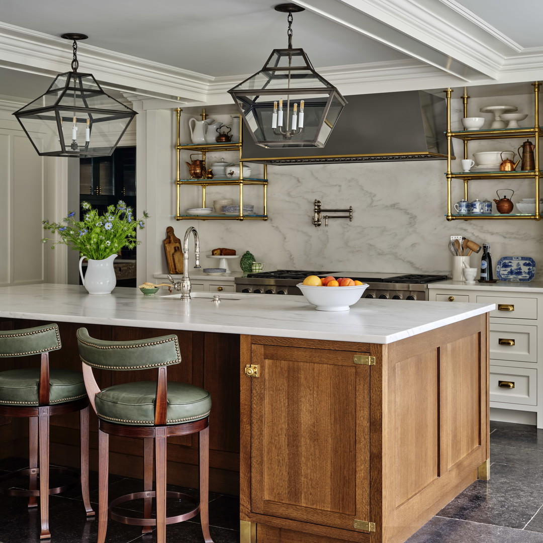 a kitchen with a marble counter top and wooden cabinets