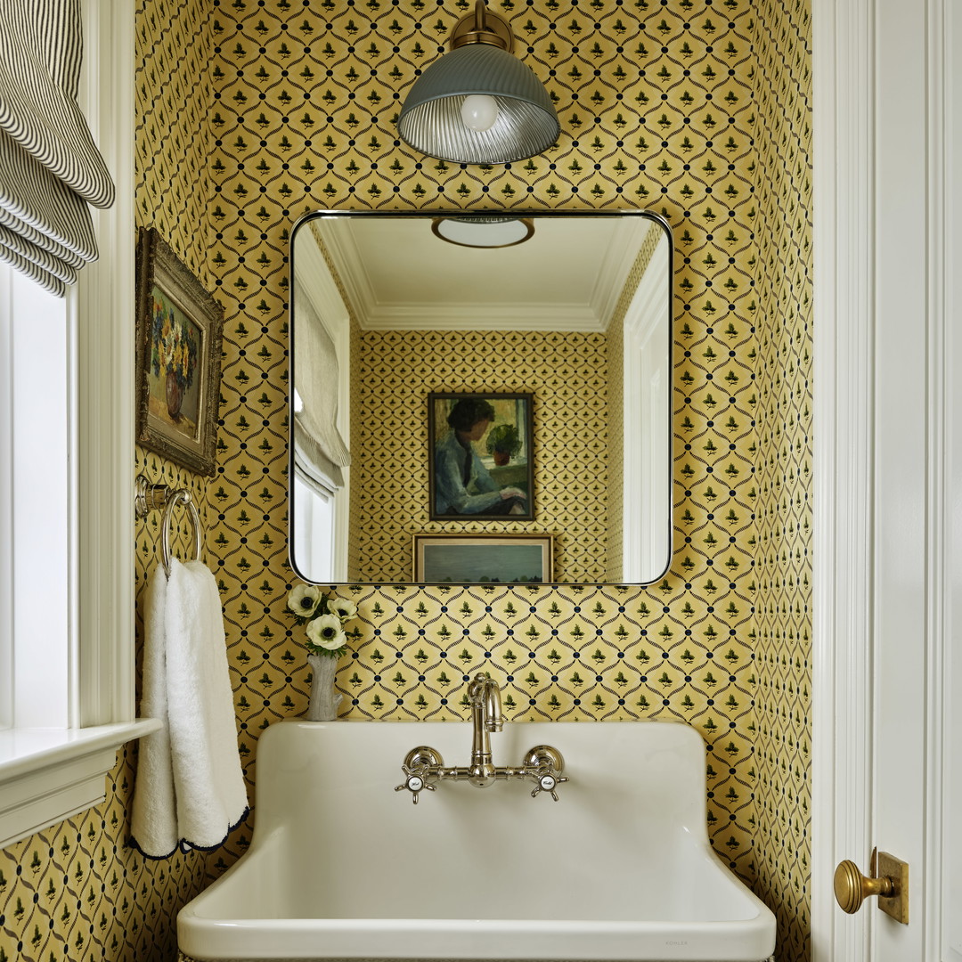 a white sink sitting under a mirror in a bathroom