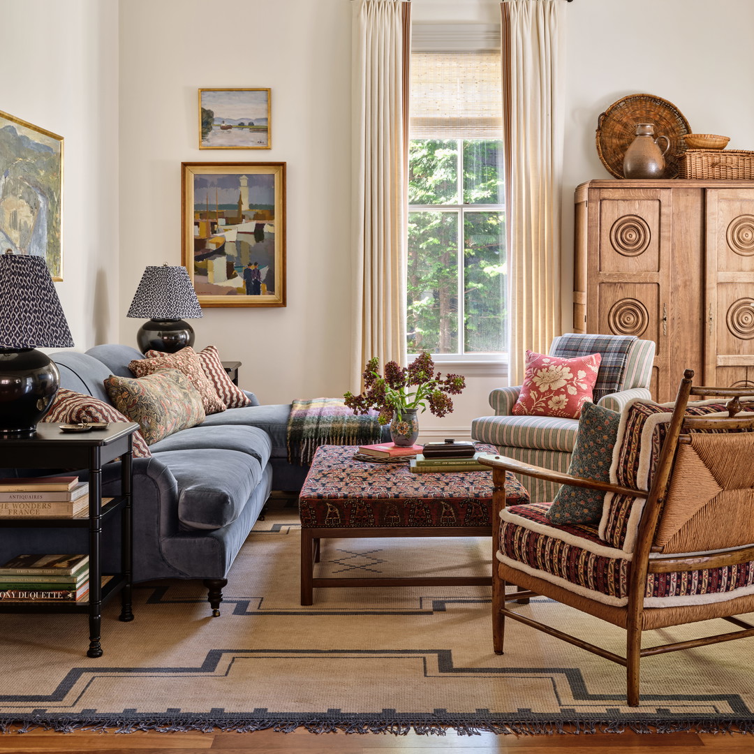 a living room filled with furniture and a large window