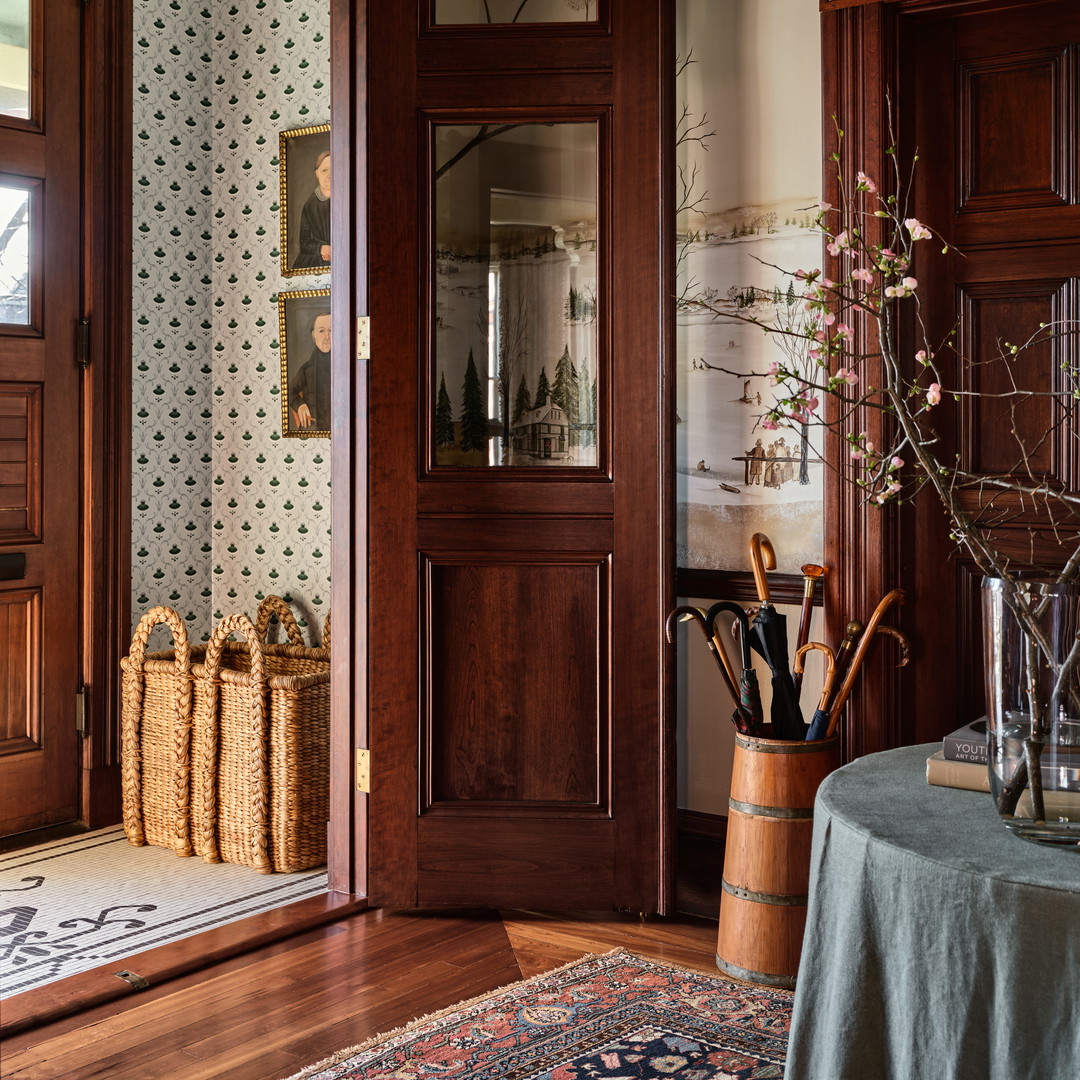 a room with a table, vases and a door