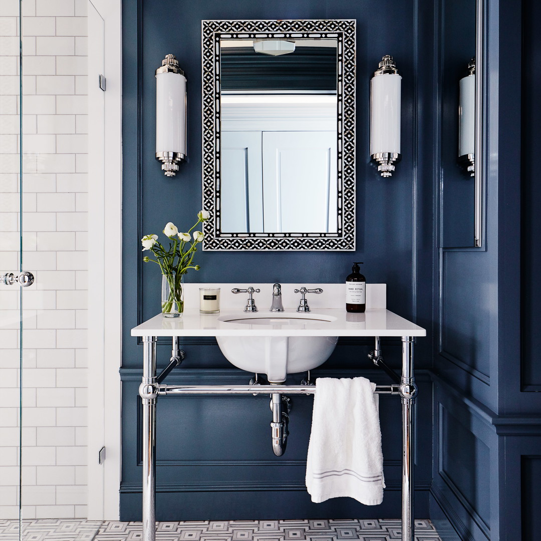 a white sink sitting under a mirror in a bathroom