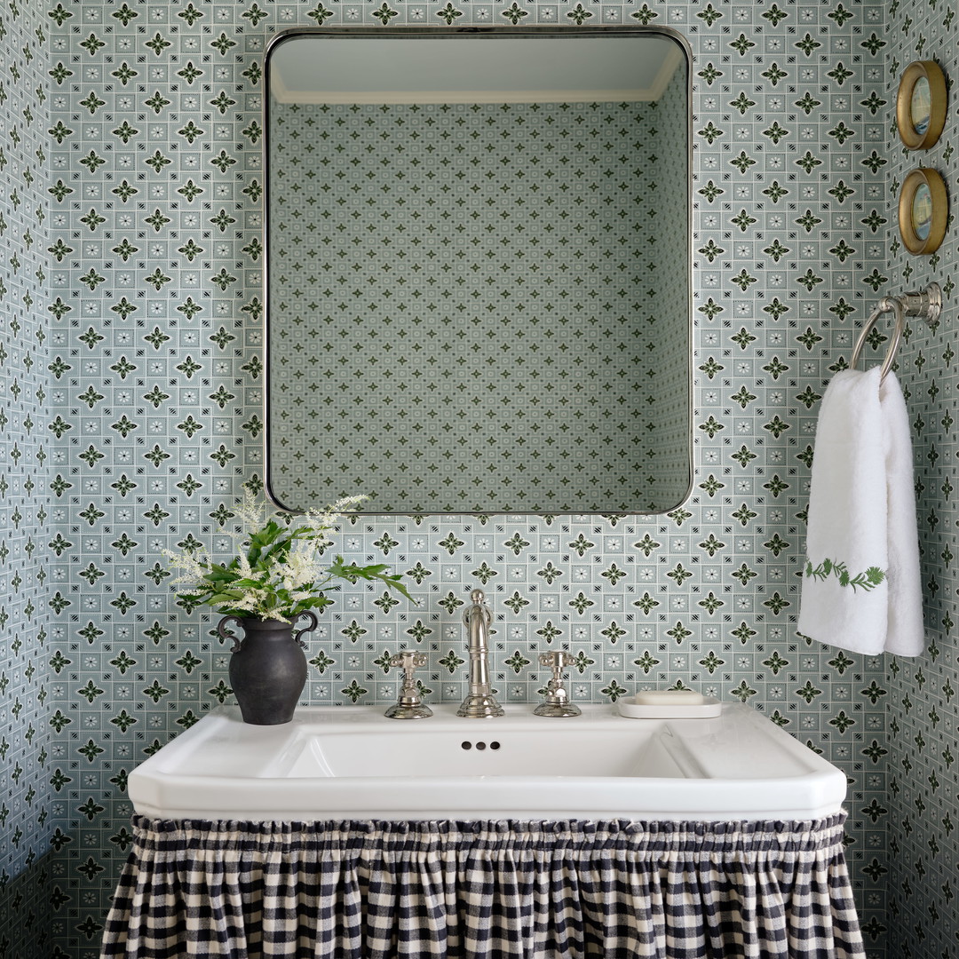 a white sink sitting under a mirror in a bathroom