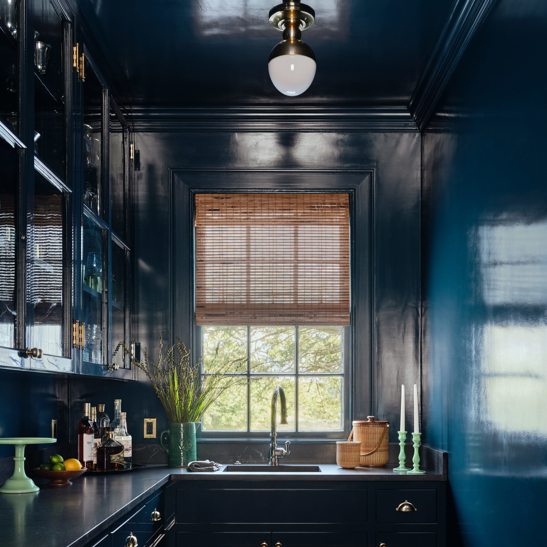 a kitchen with blue walls and wooden floors