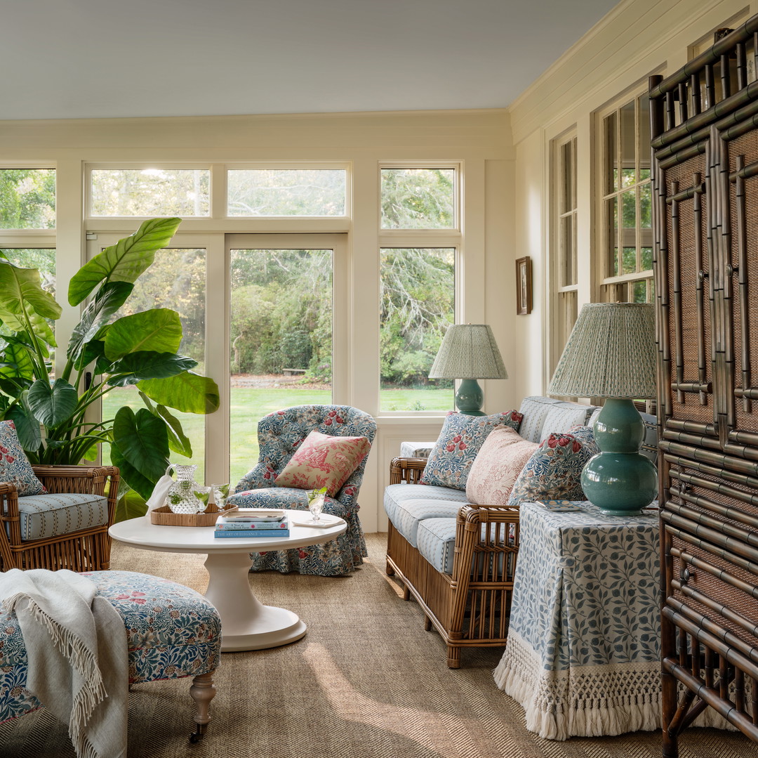 a living room filled with furniture and a large window