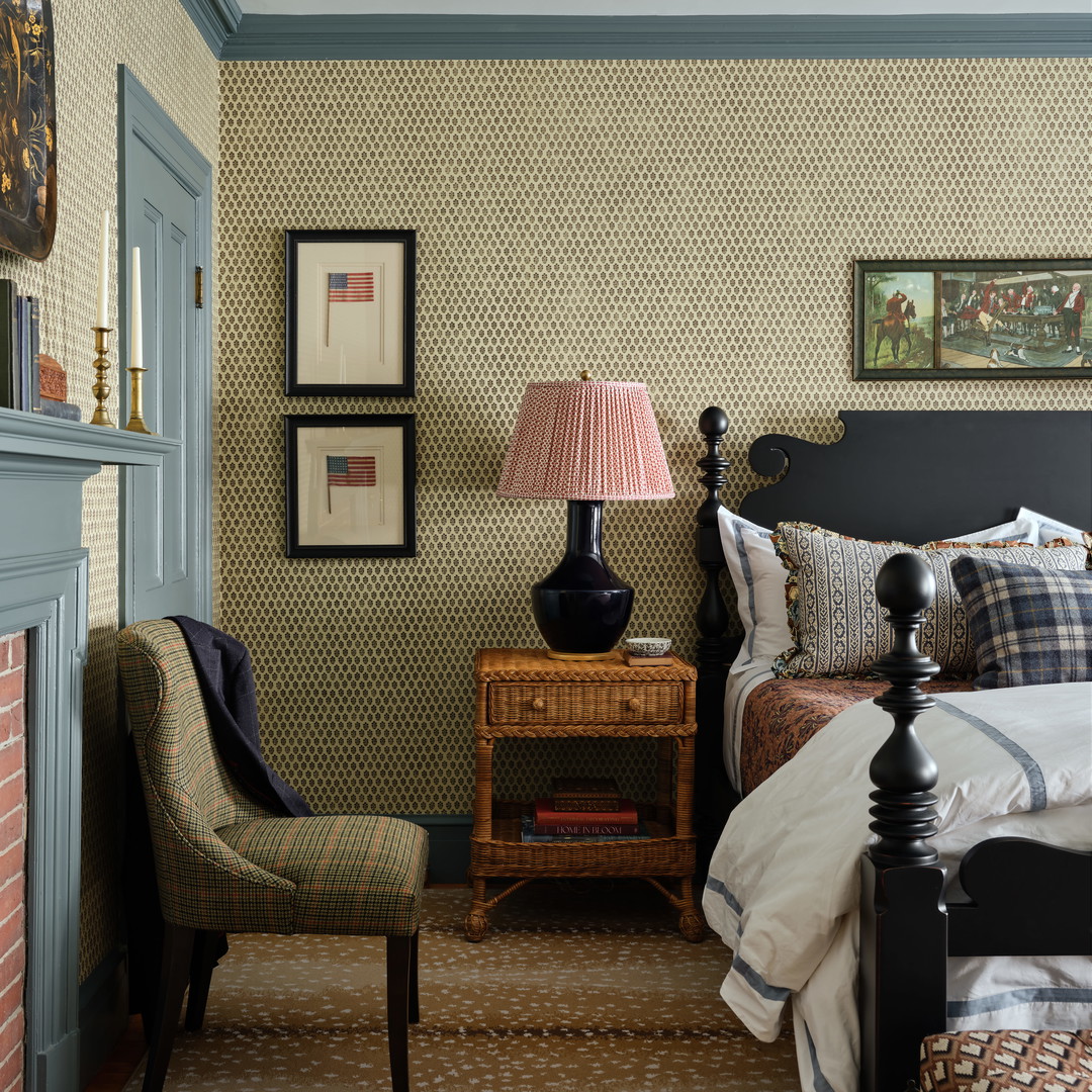 a bed room with a neatly made bed and a chair