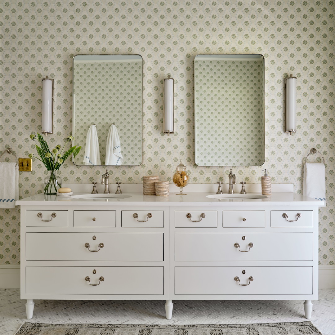 a bathroom with two sinks and a large mirror