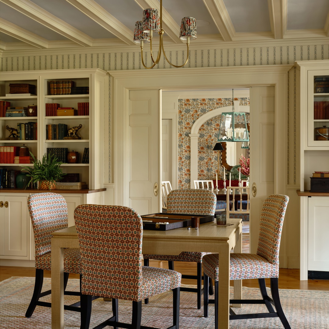 a dining room table with chairs and a chandelier