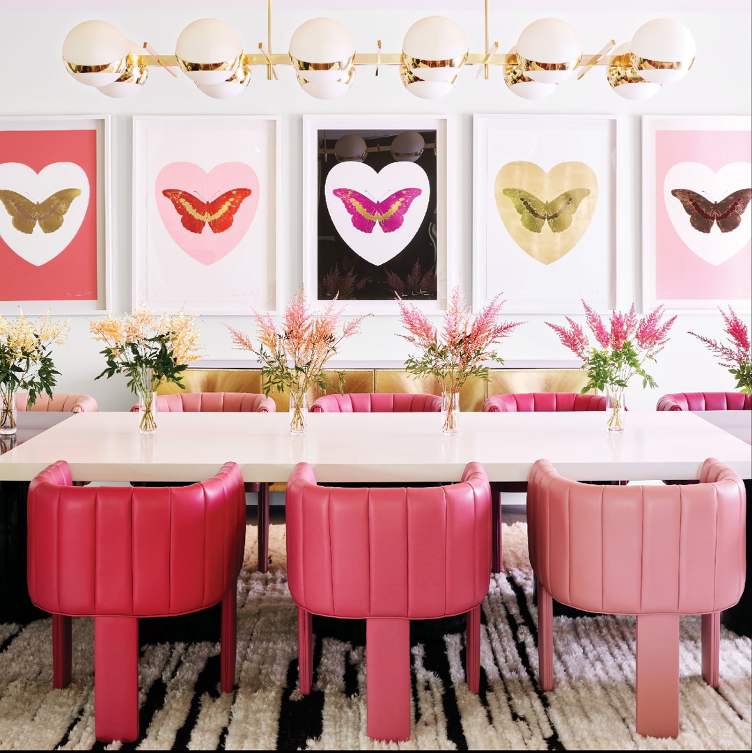 a dining room with pink chairs and a white table