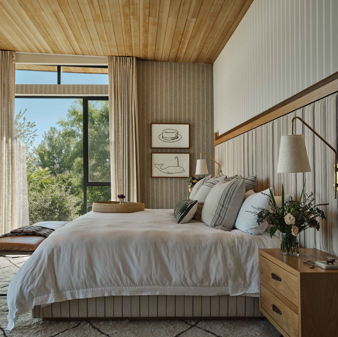 a bedroom with a large bed and a large window