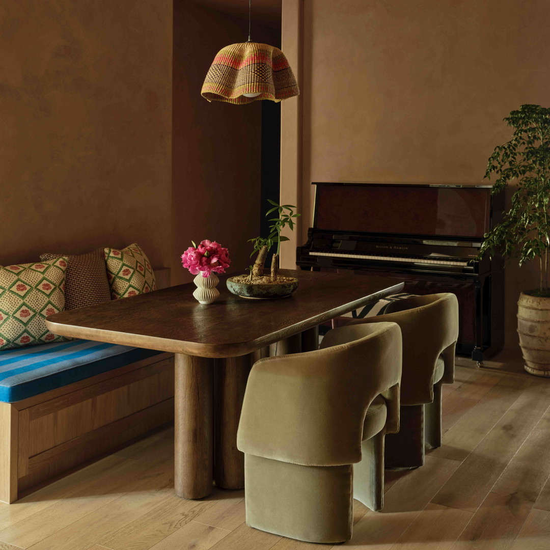 a dining room with a bench and a piano