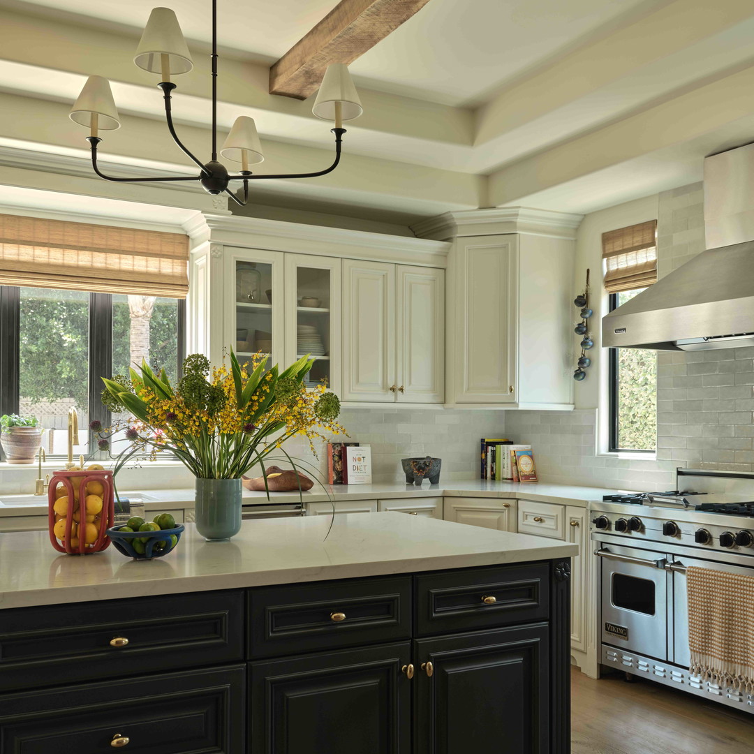 a kitchen with a center island with a vase of flowers