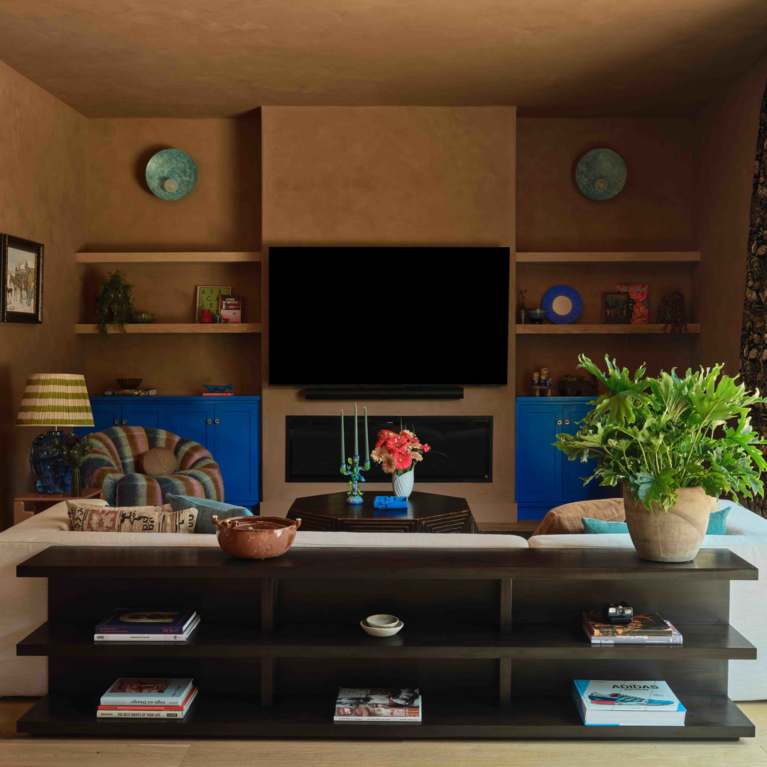 a living room filled with furniture and a flat screen tv