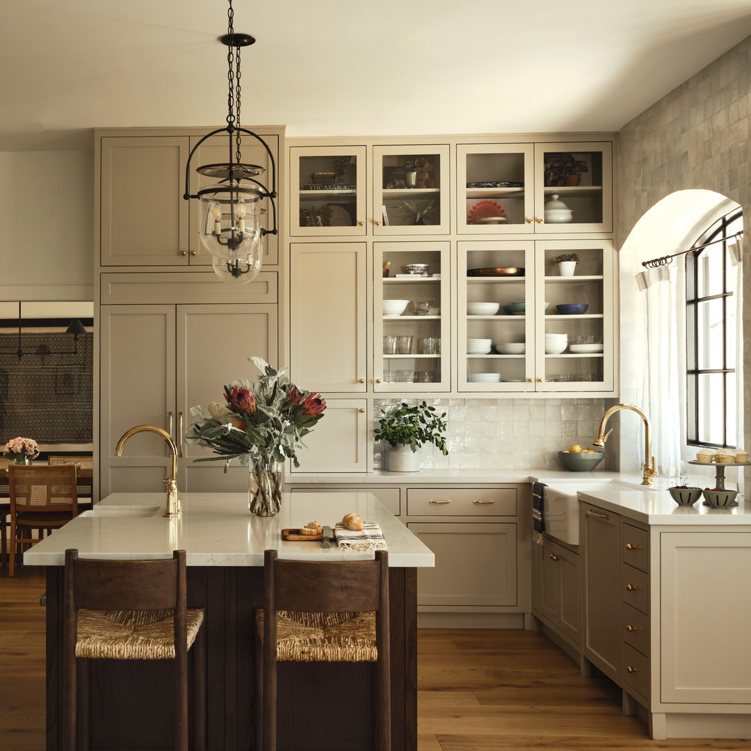 a large kitchen with a center island and wooden floors