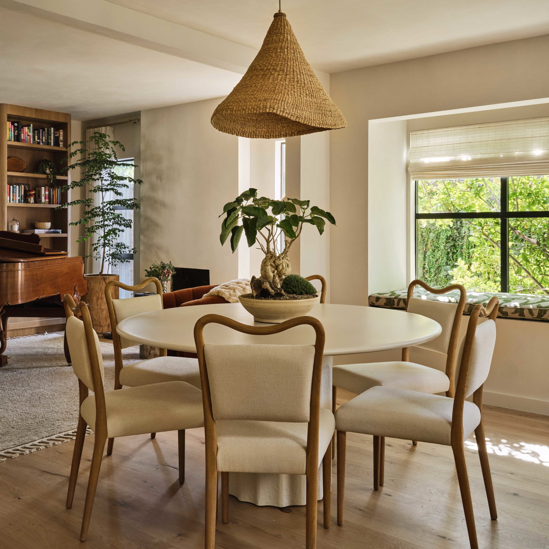 a dining room with a table and chairs