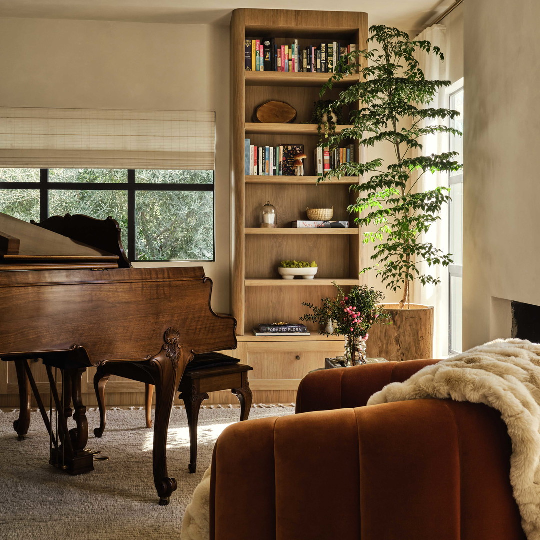 a living room filled with furniture and a grand piano