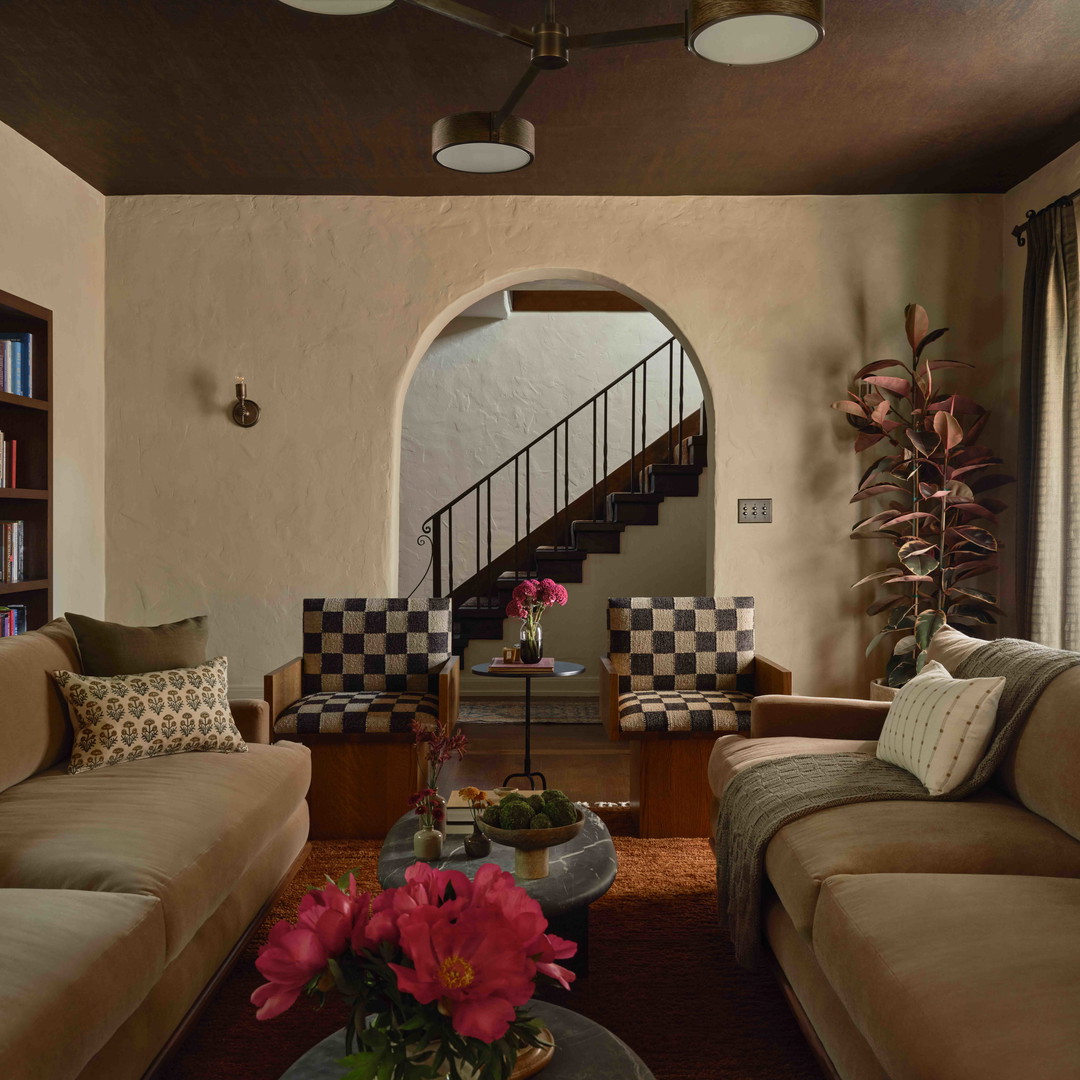 a living room filled with furniture and a staircase