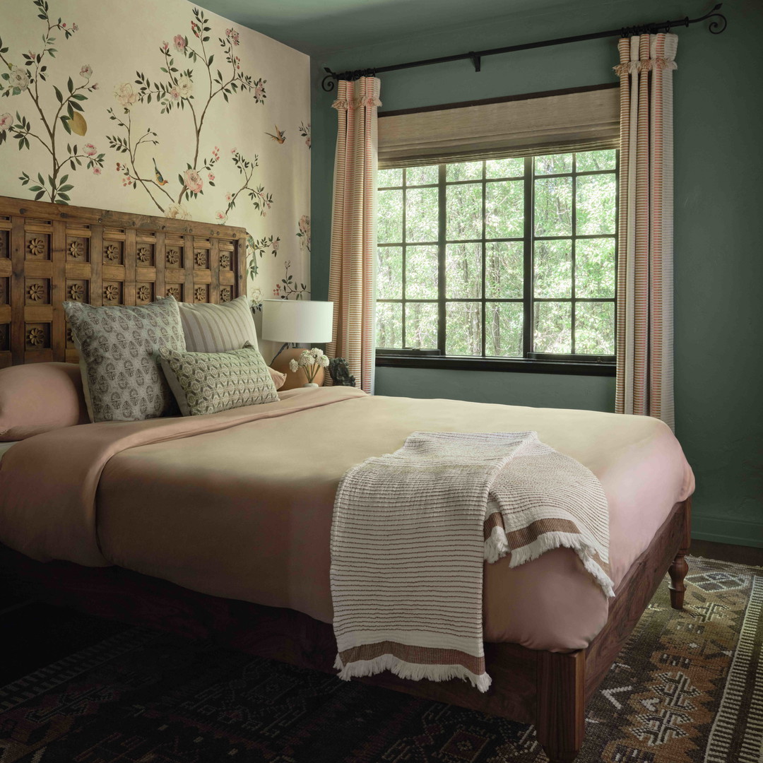 a bedroom with a large bed and a window
