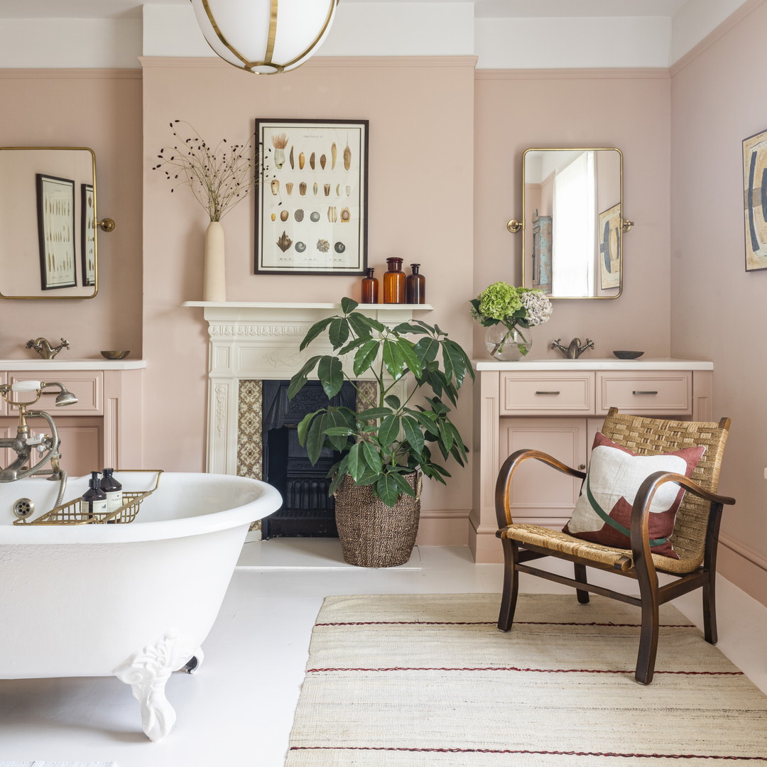 a bath room with a tub a chair and a fire place